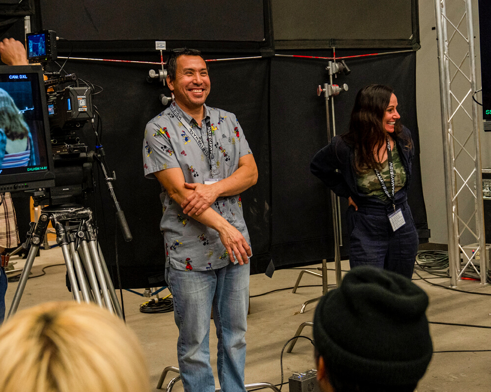 Dan Sasaki and Natasha Braier stand before a crowd of students for a demo